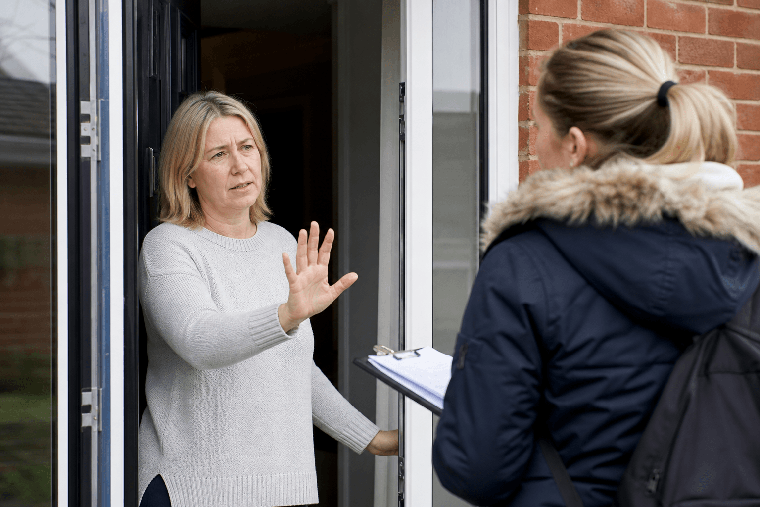 UK homeowner declining a cash-only cleaner at the front door