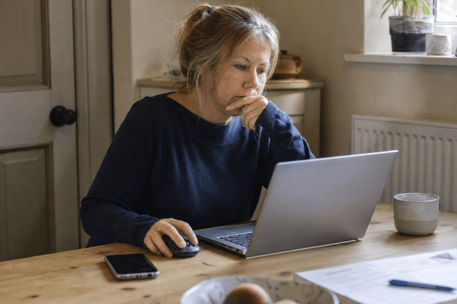 UK homeowner checking the Gas Safe Register online before booking a boiler engineer
