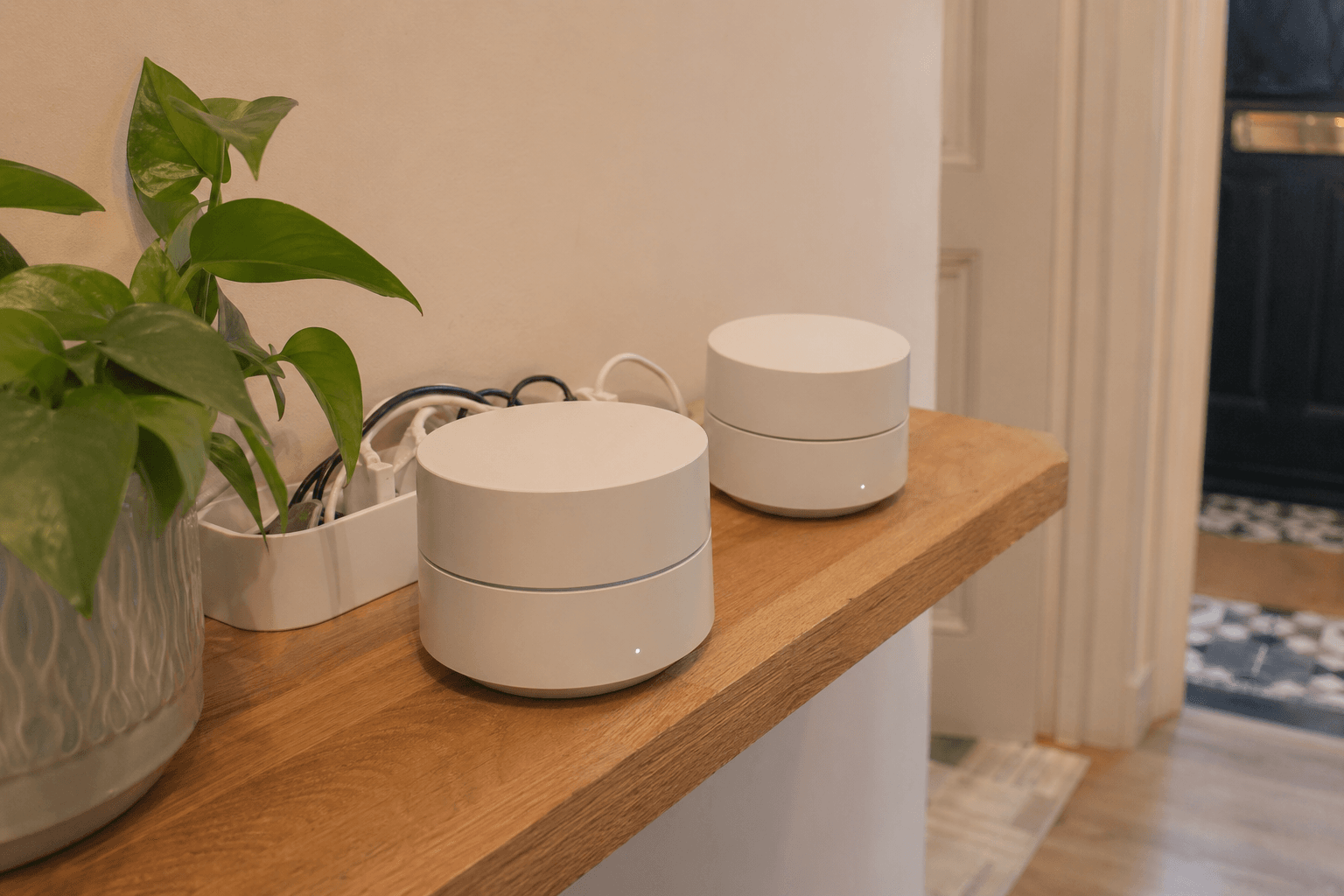 Mesh Wi-Fi units on a hallway shelf in a British home [dedupe:taskino:blog:smart-home-redo-lessons-uk:inline-3]