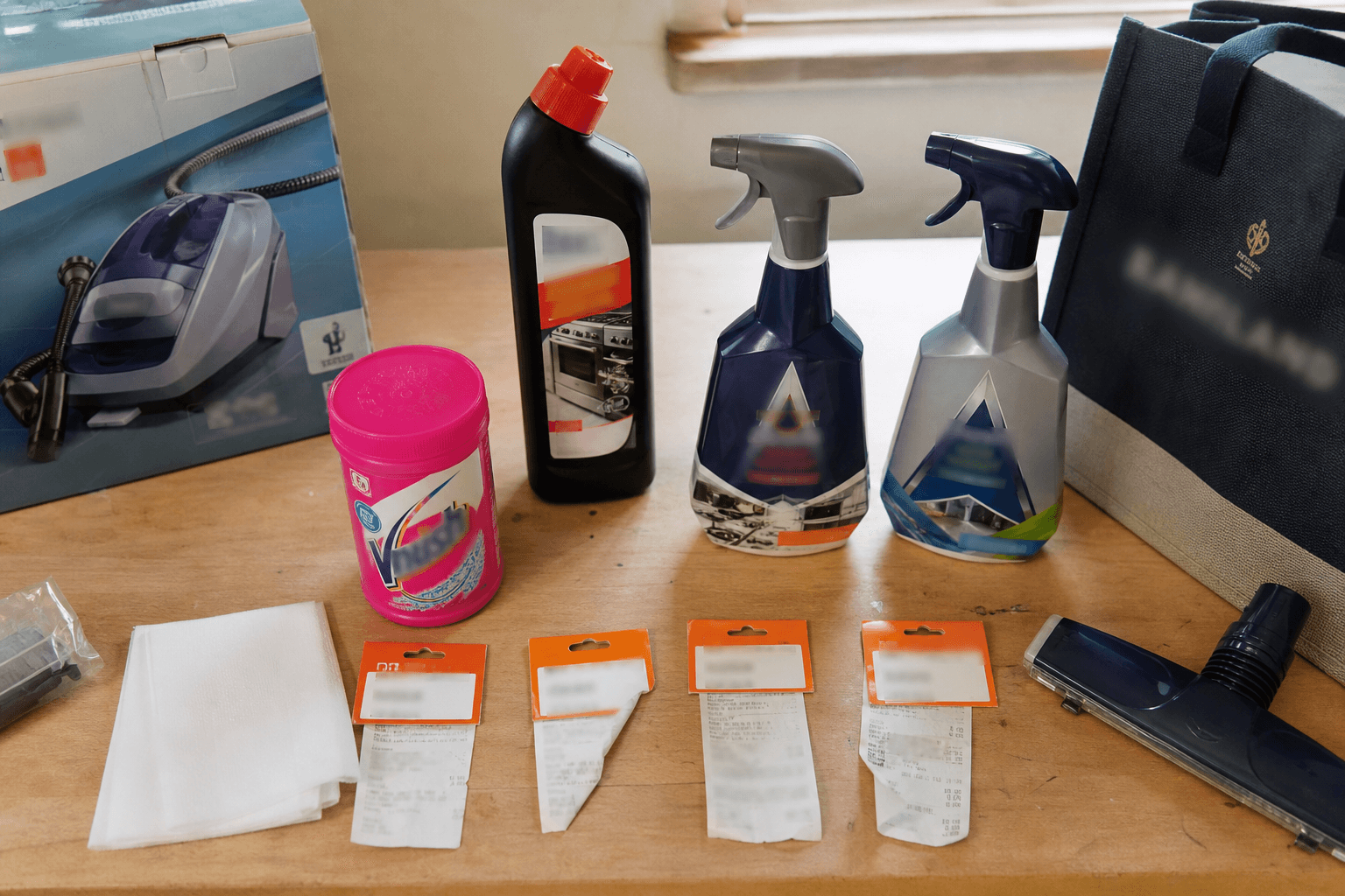 Flat-lay of UK carpet and oven cleaning products on a workbench including Vanish, Oven Mate and Astonish