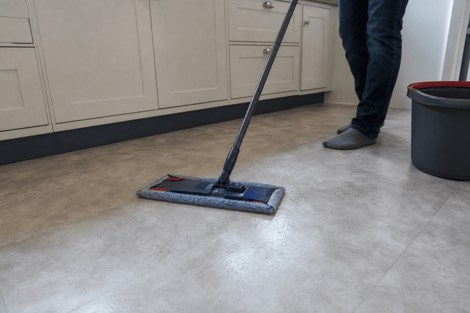 Damp mopping a kitchen floor with a microfibre mop in a UK home