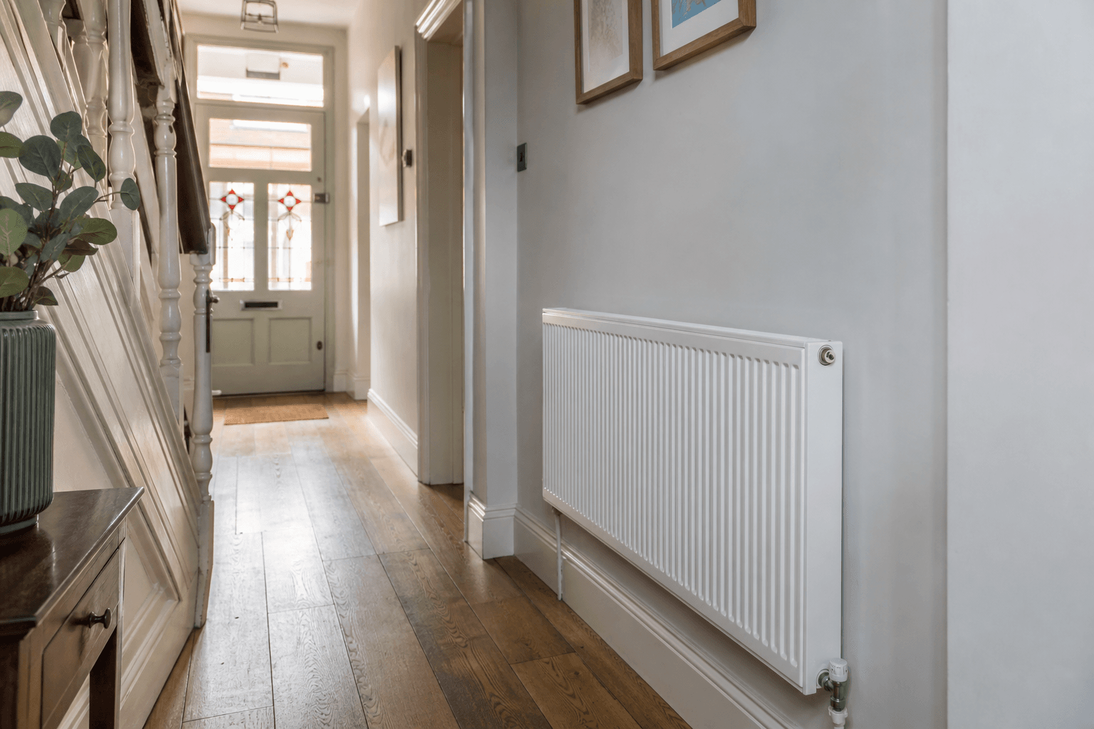 UK hallway with white panel radiator for central heating