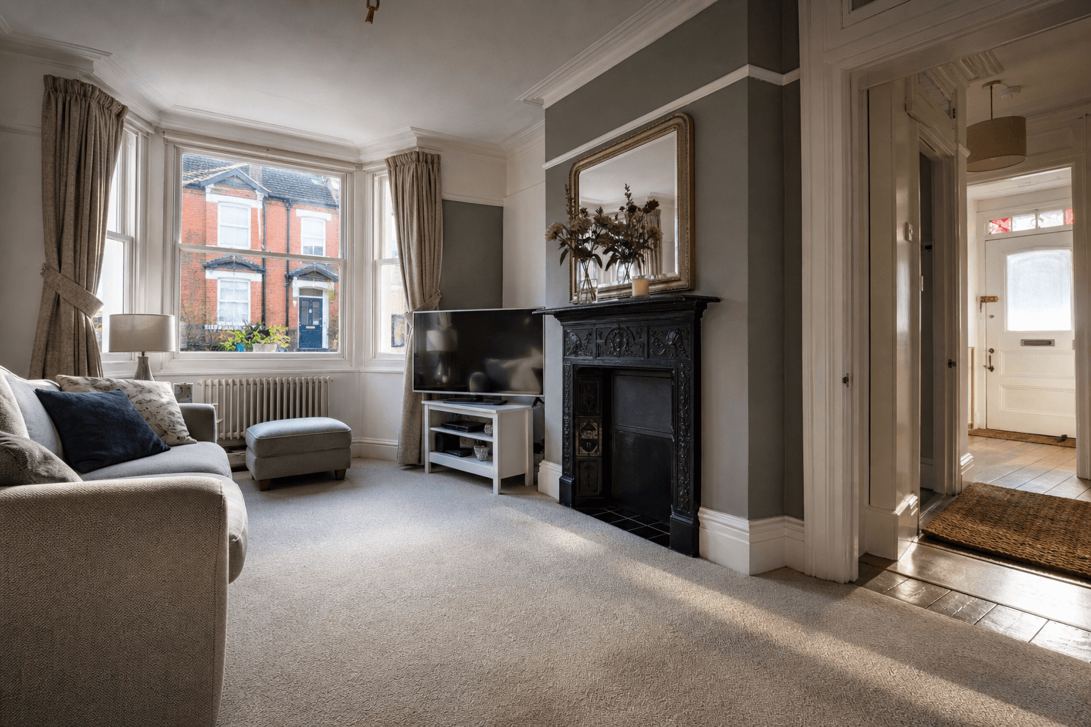 UK living room with wool carpet and sofa in soft window light