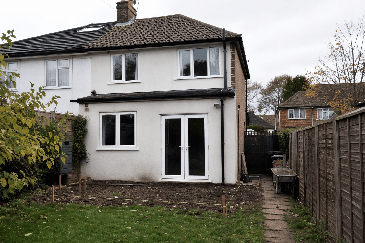 UK semi-detached rear garden with extension outline marked by stakes and string