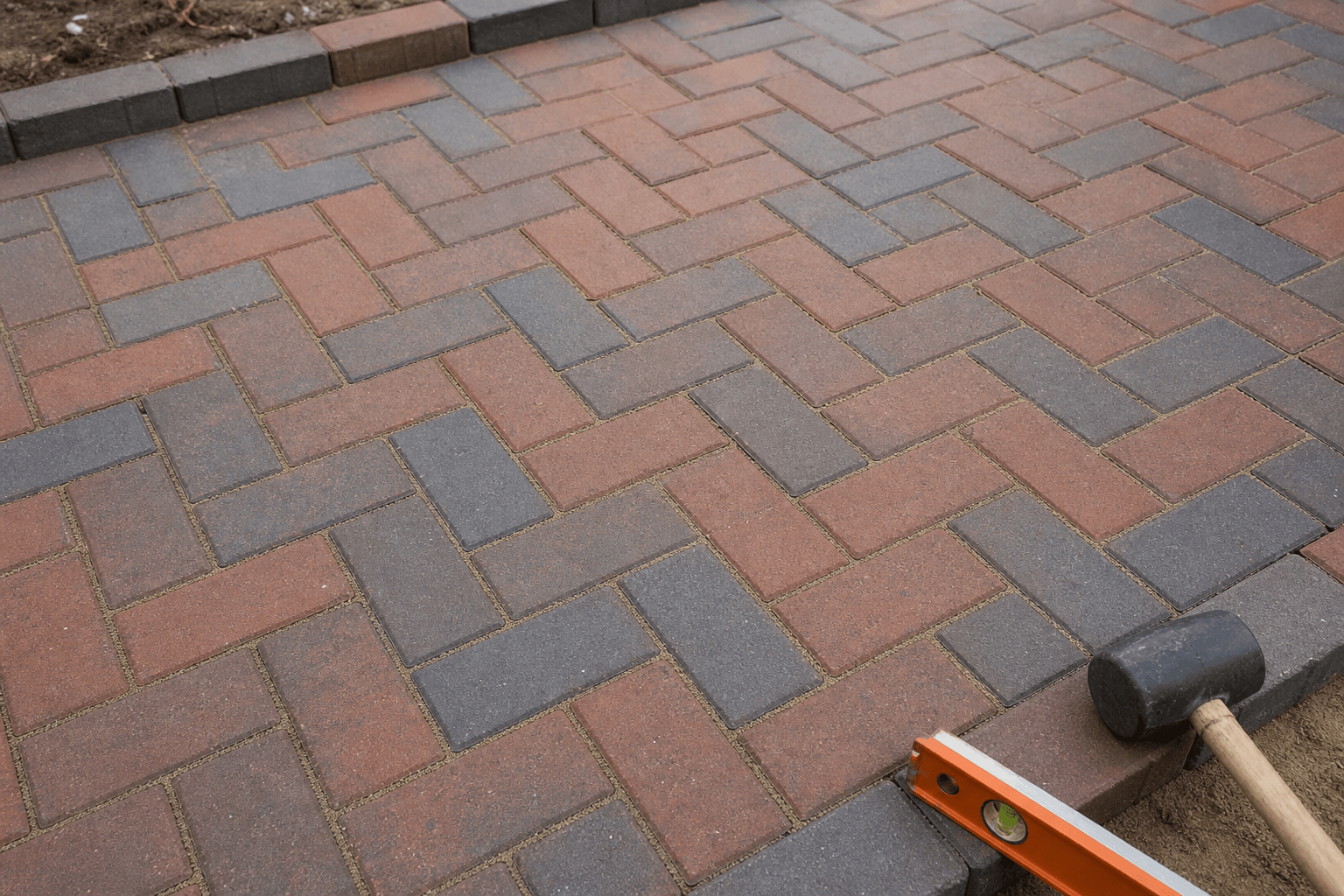Close-up of herringbone block paving joints on a UK driveway