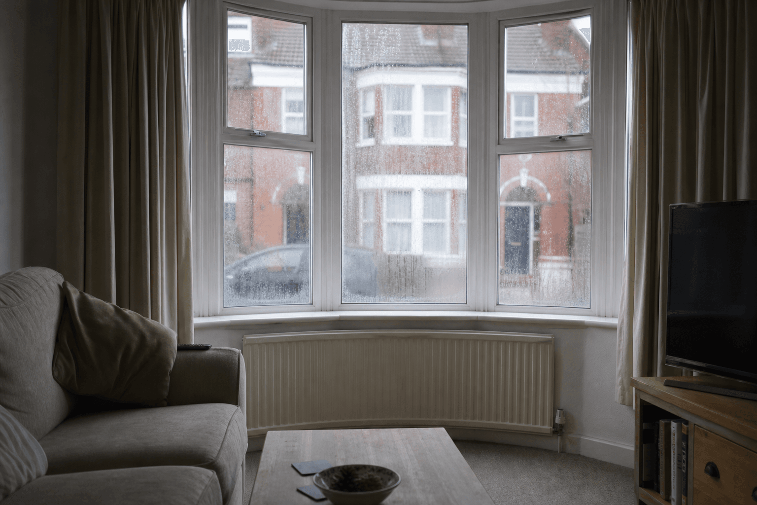 Condensation on inside of windows in a UK living room on a winter morning