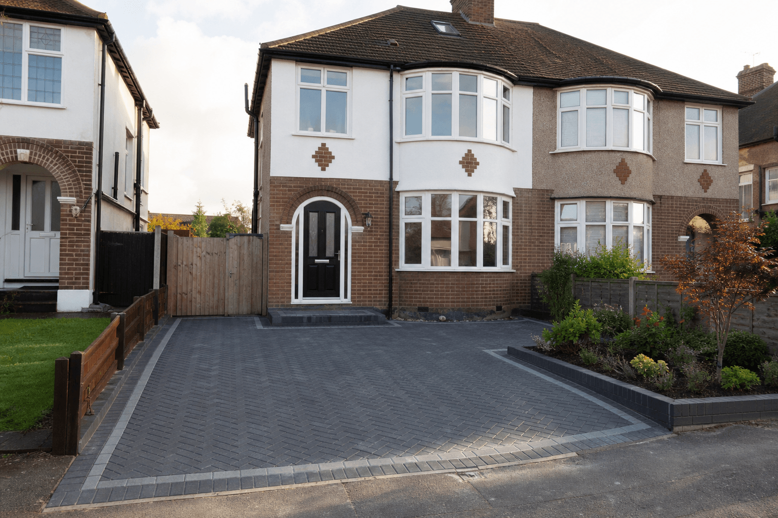 UK semi-detached home with newly laid herringbone block paving driveway in late afternoon light